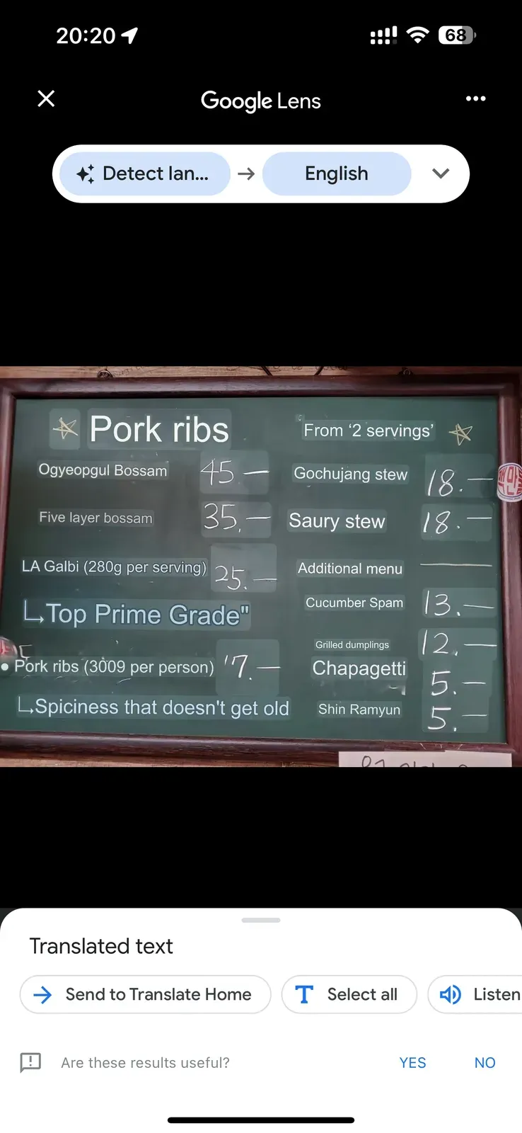 Google Lens translation of a Korean menu showing English text overlaid on the original menu, with translations like "Pork ribs" and "Five layer bossam"